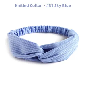 Sky blue knitted cotton headband with cross knot detail and elastic stretch band