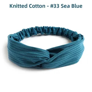 Detailed view of the sea blue knitted cotton twist headband with vertical ribbed texture