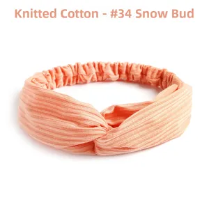 Close-up of orange knitted cotton elastic cross headband with ribbed vertical texture