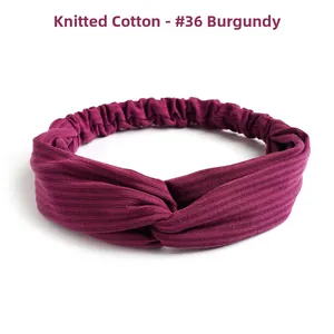 Detail of burgundy ribbed knitted cotton headband featuring a twisted knot and elastic back