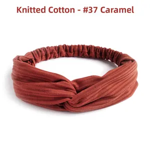 Detail of caramel knitted cotton headband showing ribbed texture and twist knot design