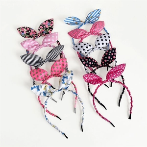 Detail shot of fabric rabbit ear headbands with floral, polka dots, and stripe patterns