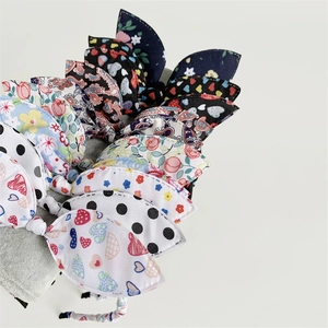 Detail of assorted bow headbands with floral, polka dot, and paisley fabric patterns