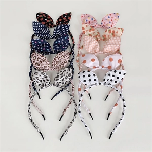 Flat lay of ten diverse floral and patterned bow bunny ear headbands for girls