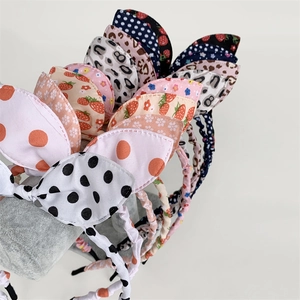 Close-up of various patterns on bow headbands including floral, polka dot and leopard