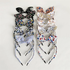 Set of 10 floral bunny ear headbands in various colors on a clean white background
