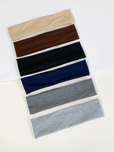 Detailed view of six-pack wide elastic knitted sports headbands in various neutral colors