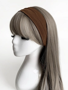Close-up of wide dark brown elastic yoga headband on a mannequin head for sports