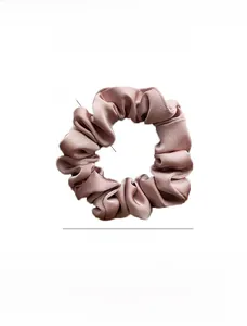 Detail showing the 8cm diameter and 2cm width of this pink satin scrunchie fabric