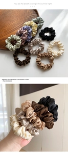 Detail view of smooth satin scrunchies in various Morandi colors with silk shine