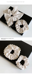 Détail de chouchous crème à pois avec bordure en dentelle blanche et nœuds décoratifs