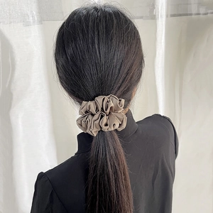 Elegant glossy brown satin scrunchie shown in a back-view hairstyle for women
