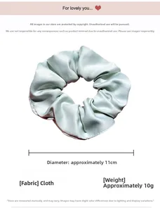 Detail view of mint green fabric scrunchie showing 11cm diameter and soft pleated texture