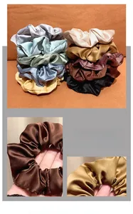 Close-up of silk oversized hair scrunchies with elegant pleats and shiny metallic texture