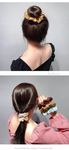 Detail of silk satin scrunchies in various colors showing ponytail styling and texture