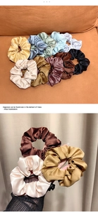 Detailed macro view showing the glossy satin texture and elastic band of large hair scrunchies