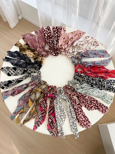 Détail d'un lot de chouchous en mousseline à motifs floraux avec de longs rubans