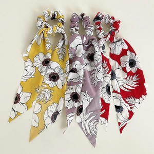 Floral print hair scrunchies with long ribbons in yellow, purple, and red colors