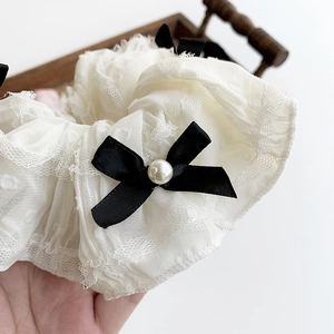 Elegant white lace scrunchie with black ribbon bow and pearl accents for women