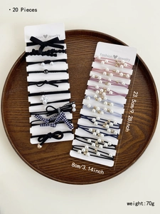 Detailed close-up of 20-piece elastic hair tie set with pearls and bows on display cards