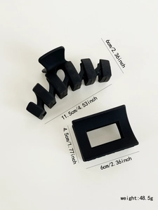 Detail view of matte black large hair claws showing wave and square shapes with measurements