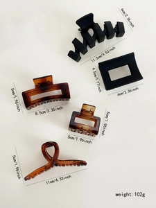 Detailed view of 5-piece hair claw set with matte black and amber colors and size specs