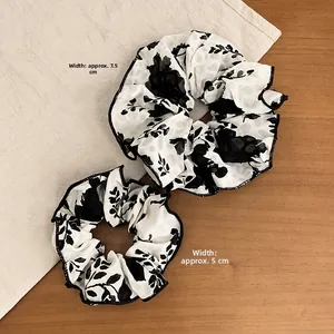 Detail view of ink wash floral scrunchie set showing 7.5cm and 5cm width dimensions