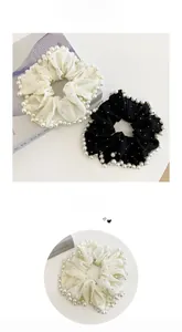 Detail of large mesh scrunchies with pearl edges and small rhinestones in black and white