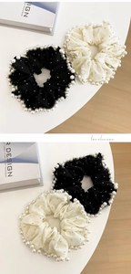 Detail of embroidered pearl mesh hair scrunchie with rhinestones in black and cream