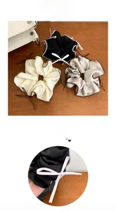 Detailed view of satin scrunchies with ribbon bows and contrast stitching in three colors