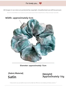 Detail showing 13cm diameter green tie-dye satin scrunchie with silky fabric texture