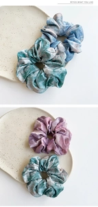 Close-up of tie-dye satin hair scrunchies with elastic texture and vibrant gradients