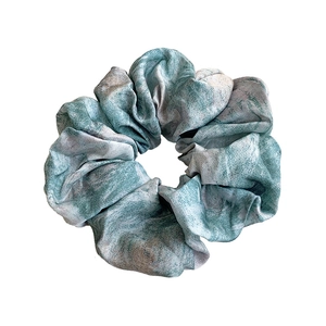 Elastic tie-dye satin scrunchie in teal and white marble pattern for women