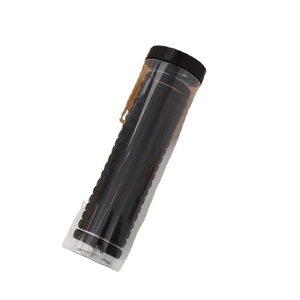 Elastic black hair ties in a cylindrical clear plastic storage bottle for hair styling