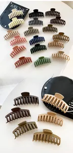 Detailed macro view of large matte hair claw clips in various Morandi colors for thick hair