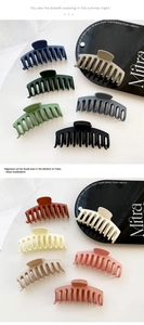 Detail view of large matte hair clips in various Morandi colors on a white background
