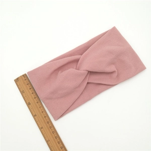 Pink ribbed knit headband detail with wooden ruler showing approx eleven centimeters width