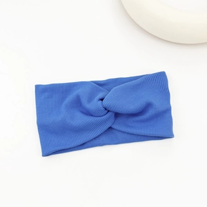 Close-up of royal blue ribbed fabric headband with a stylish central twist knot detail