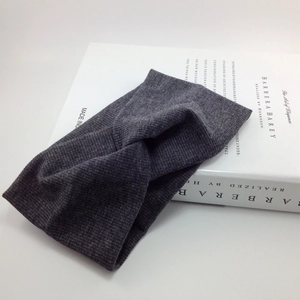 Elastic dark grey ribbed knit headband with a knot twist for sports and yoga fitness