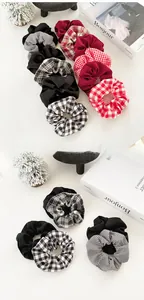 Detail of plaid and solid color fabric scrunchies set with soft texture on a white desk