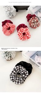 Close-up of stylish plaid and solid scrunchies with elastic fabric texture details