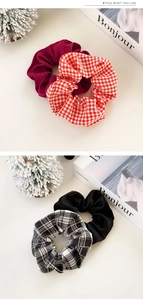 Close-up of assorted plaid and solid color fabric scrunchies with elastic texture