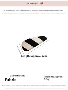 Close-up of fabric hair clip with black and white stripes measuring 7cm by 3cm