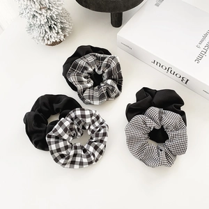 Set of minimalist black and plaid checkered hair scrunchies with soft fabric texture