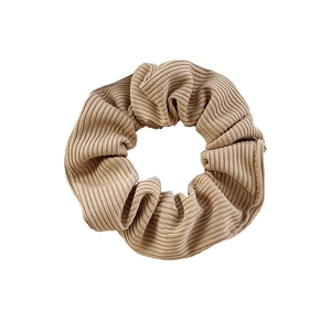 Minimalist light khaki velvet scrunchie with ribbed texture and elastic band