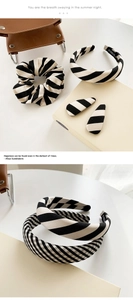 Detailed view of black and white striped hair accessories including scrunchies and headbands