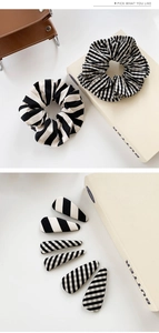 Close-up of black and white striped scrunchies and fabric hair clips set in elegant style