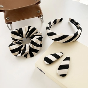Elegant black and white striped hair accessories set with headband, scrunchie, and clips