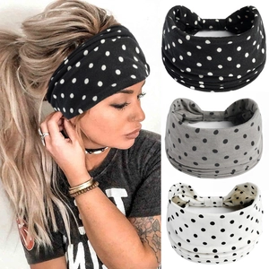 Gros plan sur des bandeaux de yoga à pois noirs, blancs et gris en tissu élastique doux