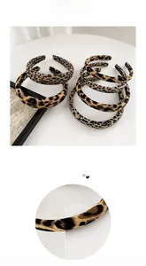 Detail of leopard print headbands showing fabric texture and handmade craft quality